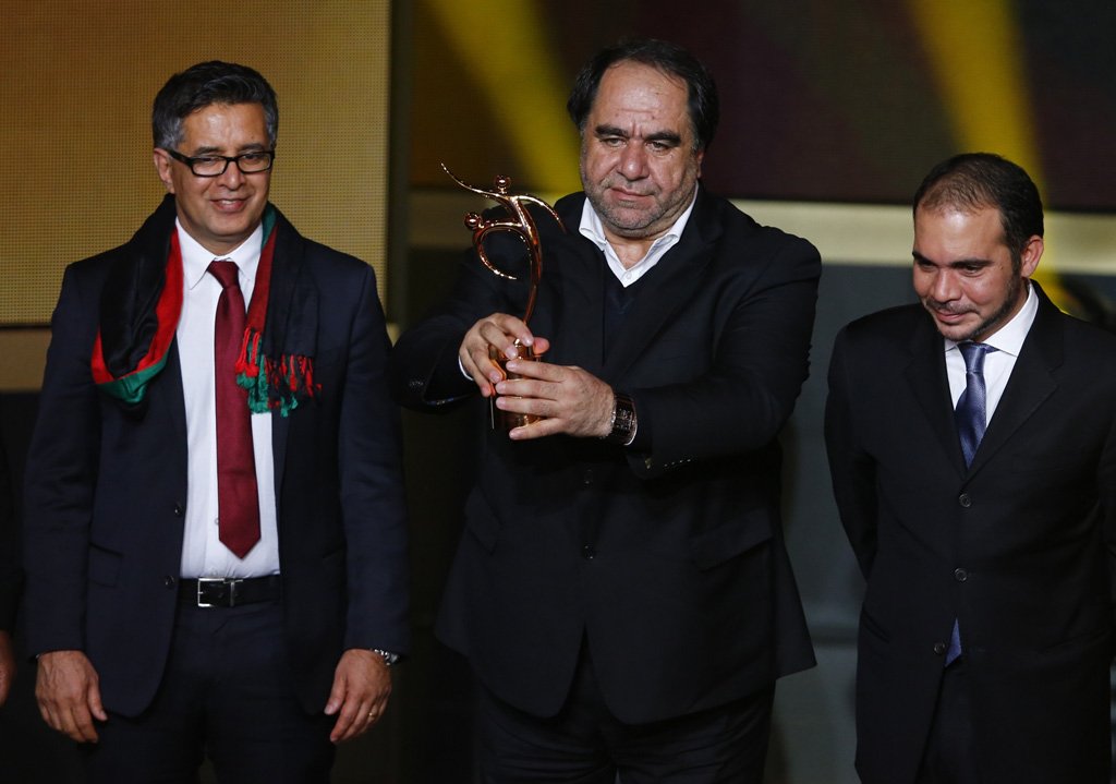 afghanistan football federation president karim keramuddin c holds the trophy after the afghanistan football federation received the fifa fair play award during the fifa ballon d 039 or 2013 soccer awards ceremony in zurich january 13 2014 photo reuters