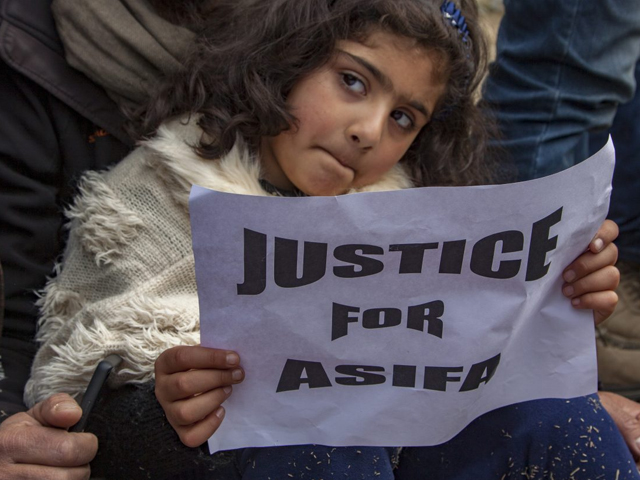 a child holds a placard as she takes part in a protest demanding the death penalty for the suspects in the rape and murder of eight year old asifa photo getty