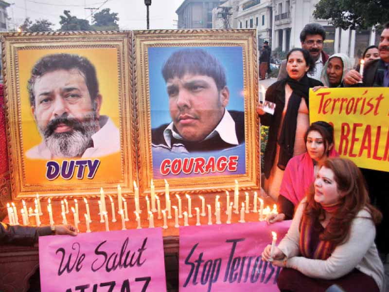 civil society members light candles in the memory of aslam and hasan photo abid nawaz