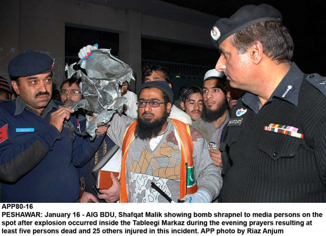 a police officer showing bomb sharpnel after the explosion at the tableghi markaz in peshawar on january 16 2014 photo app a police officer showing bomb sharpnel after the explosion at the tableghi markaz in peshawar on january 16 2014 photo app
