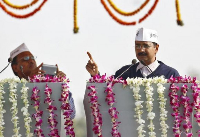 a supporter of arvind kejriwal r leader of aam aadmi common man party aap uses his mobile phone to take photo of kejriwal addressing his supporters after taking oath as the new chief minister of delhi during a swearing in ceremony at ramlila grounds in new delhi december 28 2013 photo reuters a supporter of arvind kejriwal r leader of aam aadmi common man party aap uses his mobile phone to take photo of kejriwal addressing his supporters after taking oath as the new chief minister of delhi during a swearing in ceremony at ramlila grounds in new delhi december 28 2013 photo reuters