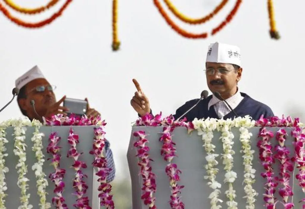 a supporter of arvind kejriwal r leader of aam aadmi common man party aap uses his mobile phone to take photo of kejriwal addressing his supporters after taking oath as the new chief minister of delhi during a swearing in ceremony at ramlila grounds in new delhi december 28 2013 photo reuters a supporter of arvind kejriwal r leader of aam aadmi common man party aap uses his mobile phone to take photo of kejriwal addressing his supporters after taking oath as the new chief minister of delhi during a swearing in ceremony at ramlila grounds in new delhi december 28 2013 photo reuters