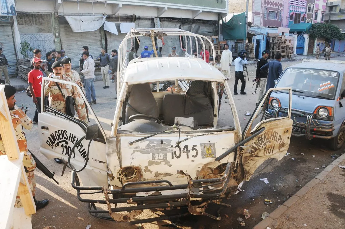 rangers officials inspect the van that was targeted by a bomb in landhi photo mohammad azeem express file rangers officials inspect the van that was targeted by a bomb in landhi photo mohammad azeem express file