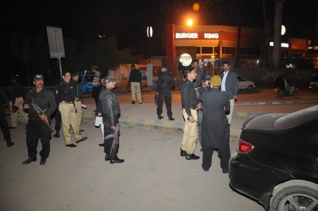 police officials inspecting the area after the attack on express news van on january 17 2014 photo express mohammad noman police officials inspecting the area after the attack on express news van on january 17 2014 photo express mohammad noman