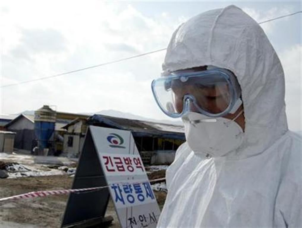 south korean soldier wearing a protective suit at a farm affected by bird flu south of seoul in a 2004 photo photo reuters