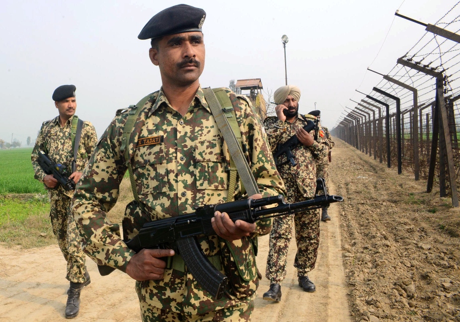 indian border security force soldiers patrol along the india pakistan border fence about 27 km from wagah on january 13 2013 photo afp