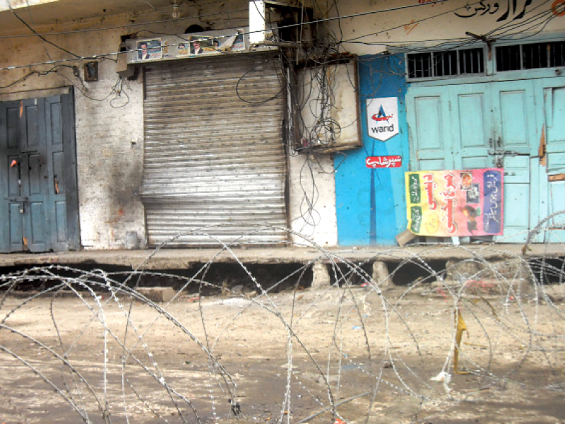 access to ra bazaar road is sealed while a number of shops unaffected by the blast were forced to stay closed photo kashif abbasi