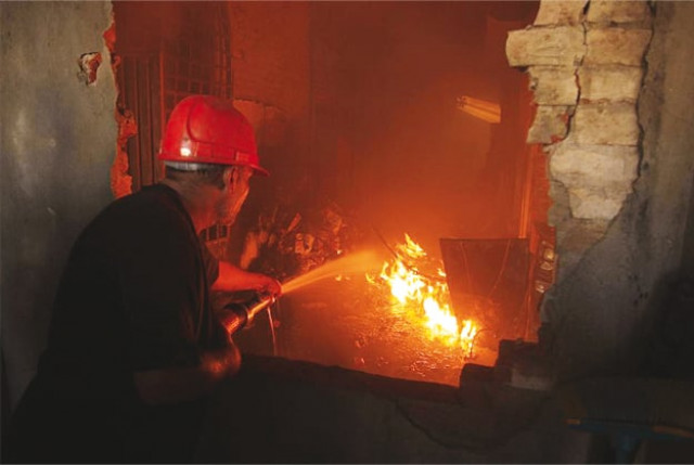 a fireman tries to extinguish a factory fire on tuesday september 11 2012 in lahore photo reuters a fireman tries to extinguish a factory fire on tuesday september 11 2012 in lahore photo reuters