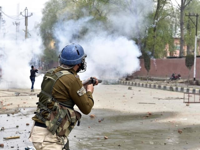 in a file photo an indian occupational troop fires tear gas in the disputed valley photo afp in a file photo an indian occupational troop fires tear gas in the disputed valley photo afp