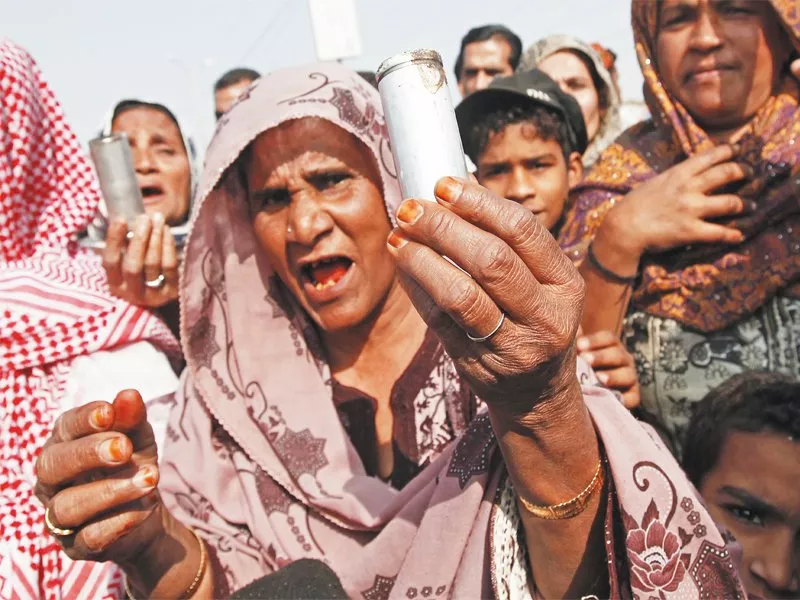 a resident of baloch colony displays an empty tear gas shell fired by the police during a protest against a search operation to look for the suspects behind the killings of three polio vaccination workers on tuesday photo reuters a resident of baloch colony displays an empty tear gas shell fired by the police during a protest against a search operation to look for the suspects behind the killings of three polio vaccination workers on tuesday photo reuters