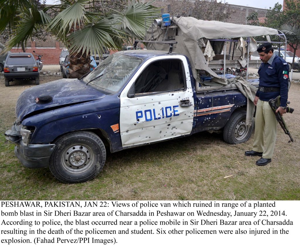 a policeman inspects the vehicle damaged in the bomb blast photo ppi