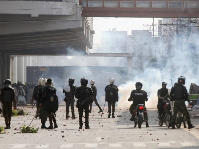 police officers stand as they use tear gas to disperse supporters of tlp during a solidarity march for gaza in lahore on october 10 2025 photo reuters police officers stand as they use tear gas to disperse supporters of tlp during a solidarity march for gaza in lahore on october 10 2025 photo reuters