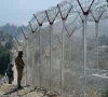 pakistani soldiers keep vigil next to newly fenced border fencing along with afghan s paktika province border in angoor adda in south waziristan photo afp