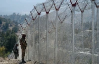 pakistani soldiers keep vigil next to newly fenced border fencing along with afghan s paktika province border in angoor adda in south waziristan photo afp