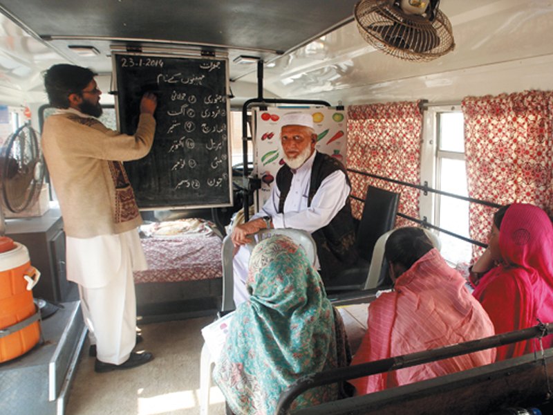 students are taught basics of reading and writing by a teacher and a teaching assistant photos athar khan express