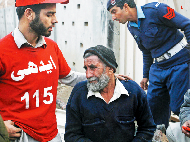 a rescue worker comforts a man over the death of his relative photo reuters