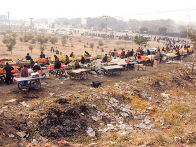 encroachers on the green belt near khanna pul on the islamabad expressway give the area the look of a dumping ground photo file encroachers on the green belt near khanna pul on the islamabad expressway give the area the look of a dumping ground photo file