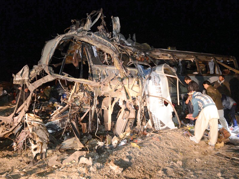 security officials and rescue workers gather at the site of the bus bombing in mastung on tuesday photo afp