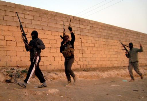 anti government fighters moving towards their position during clashes with iraqi security forces in anbar photo afp file