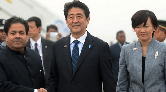 japanese prime minister shinzo abe shakes hands with indian minister of state for parliamentary affairs rajeev shukla in new delhi photo afp