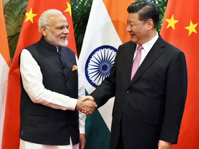 chinese president xi jinping shakes hands with indian prime minister narendra modi during their visit at east lake guest house photo afp