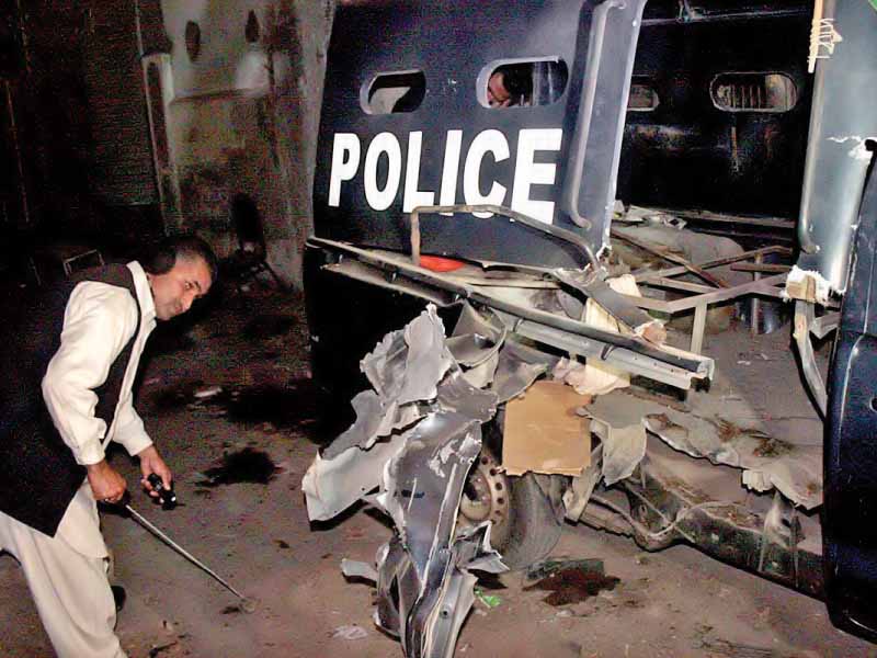 a security official collects evidence from the blast site photo online