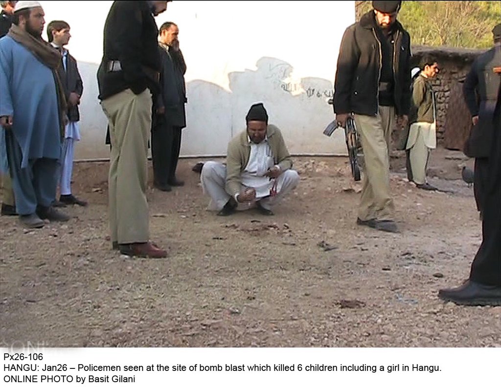 policemen inspecting the site photo online