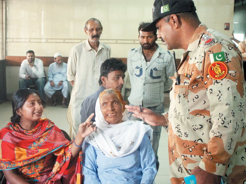 a relative of the third bomb blast at the paramilitary force on wednesday talks to a rangers official at abbasi shaheed hospital photo ppi