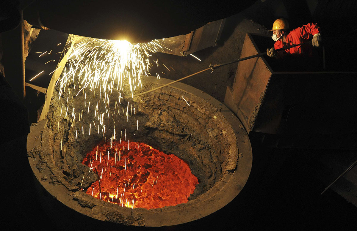 an employee works above a furnace containing molten steel at a factory of dongbei special steel group co ltd in dalian liaoning province january 30 2014 photo reuters