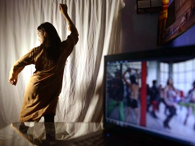 an aspiring pakistani dancer practicing her bollywood dance moves in an academy in lahore photo afp