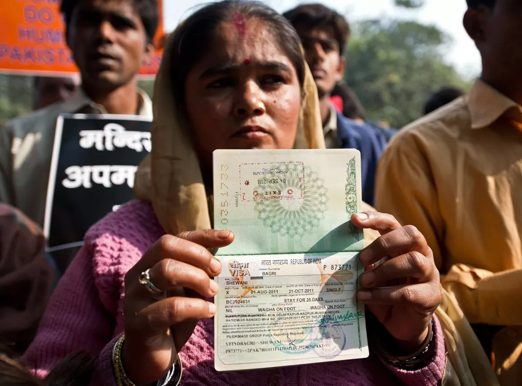 a hindu refugee from pakistan shows her now expired indian visa page on her passport photo afp a hindu refugee from pakistan shows her now expired indian visa page on her passport photo afp