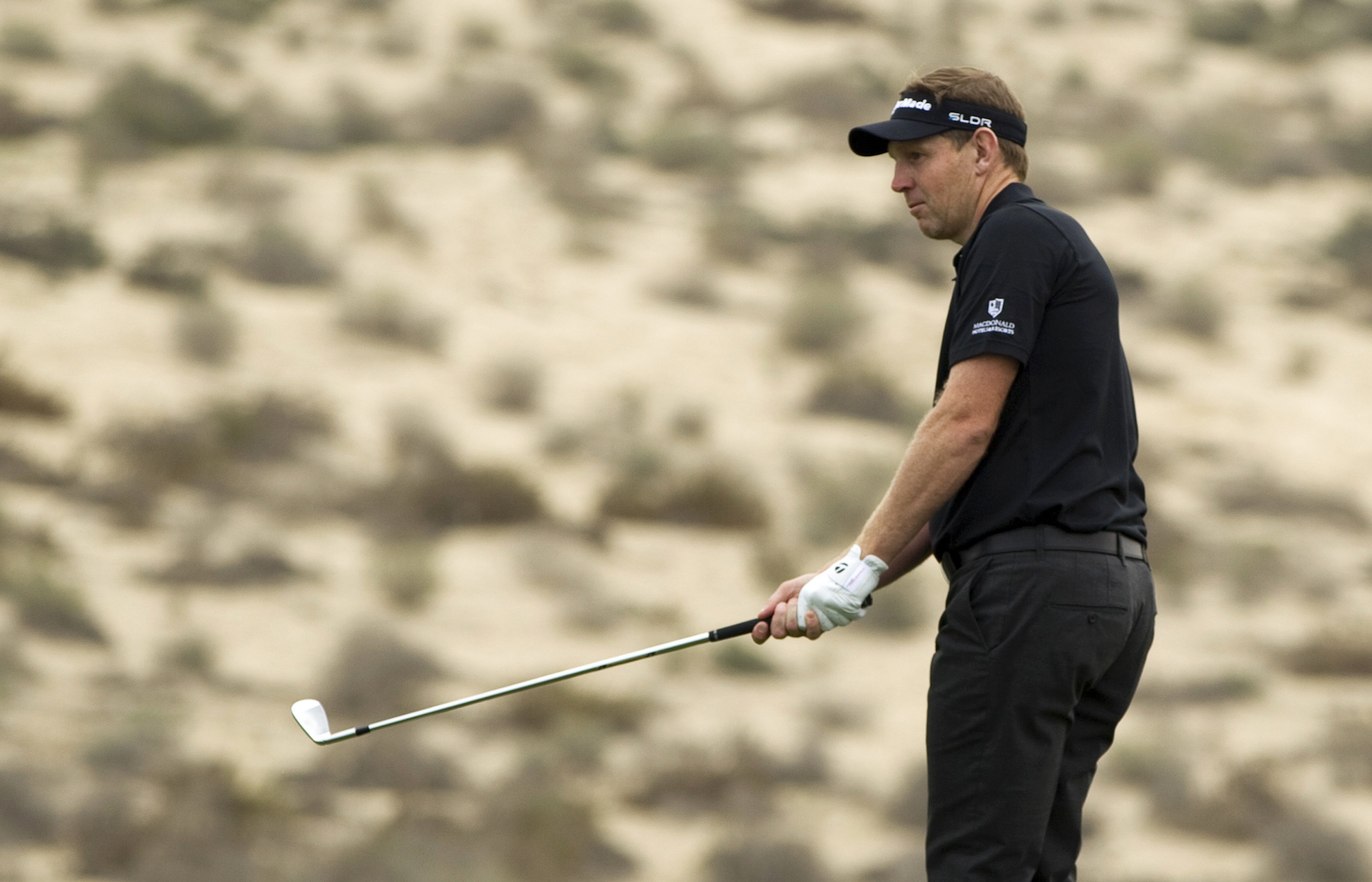 stephen gallacher of scotland watches his ball from the 8th fairway during the final round of the 2014 omega dubai desert classic in dubai february 2 2014 photo reuters