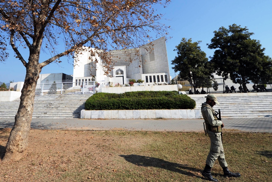 a paramilitary soldier patrols outside the supreme court building during a hearing in islamabad on december 28 2011 photo afp