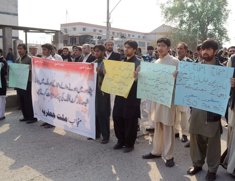 protesters held placards demanding the government arrest those behind the attack photo muhammad iqbal express