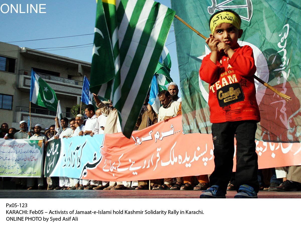 a child holds up the flag of azad kashmir during a rally in support of the kashmiri struggle photo online