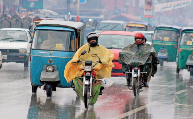 motorcyclists wear raincoats amid heavy rainfall photo muhammad iqbal express motorcyclists wear raincoats amid heavy rainfall photo muhammad iqbal express