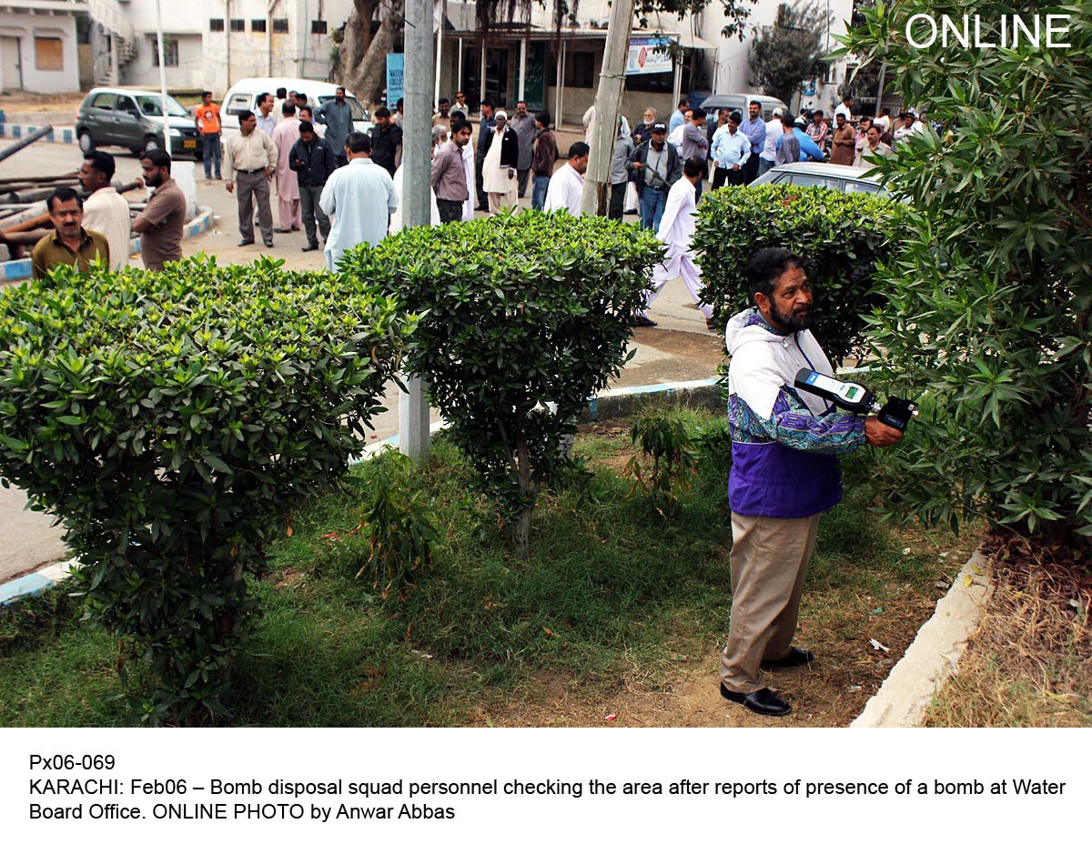 an official of the bomb disposal squad checks for a bomb outside the karachi water and sewerage board office in karachi photo online