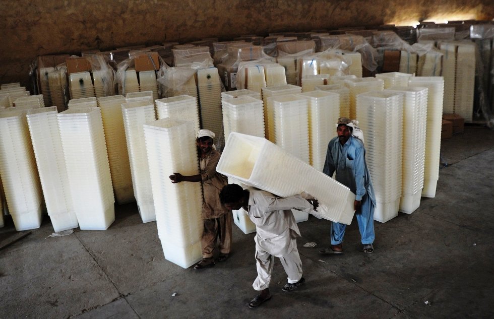 in this file photo workers carry ballot boxes to be transported to polling stations in karachi on may 6 2013 photo afp