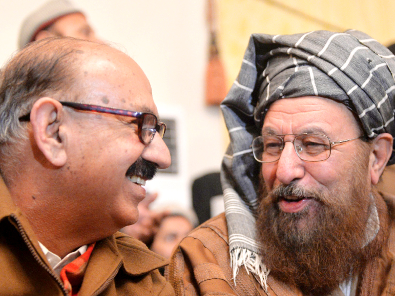 maulana samiul haq speaks to irfan siddiqui after their meeting in khyber pakhtunkhwa house in islamabad photo afp