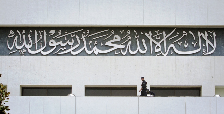 a policeman keeps guard near an inscription written on the parliament building in islamabad march 20 2012 photo reuters