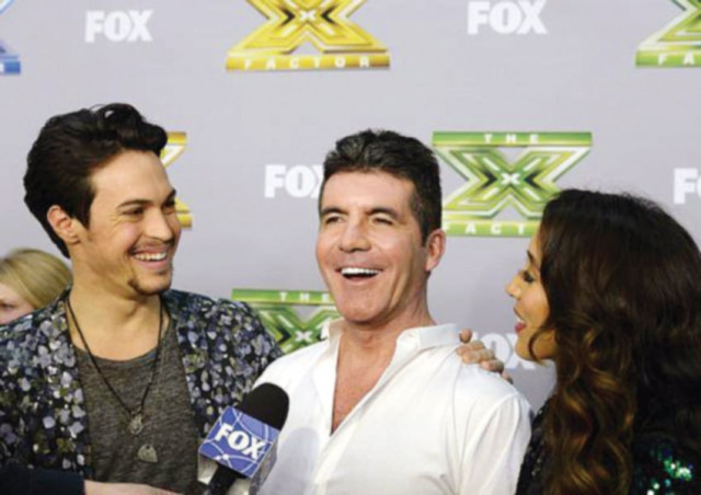 alex kinsey and sierra deaton with their mentor and judge simon cowell as he speaks during an interview after the folk duo won the x factor last year photo file
