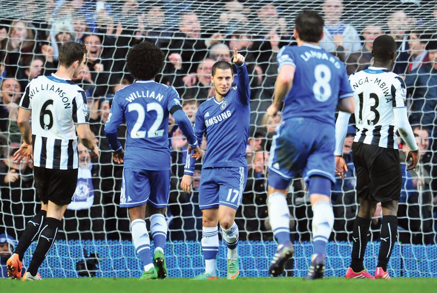 eden hazard struck two first half goals against newcastle and then completed his first treble in chelsea s colours from the penalty spot in the second half photo afp