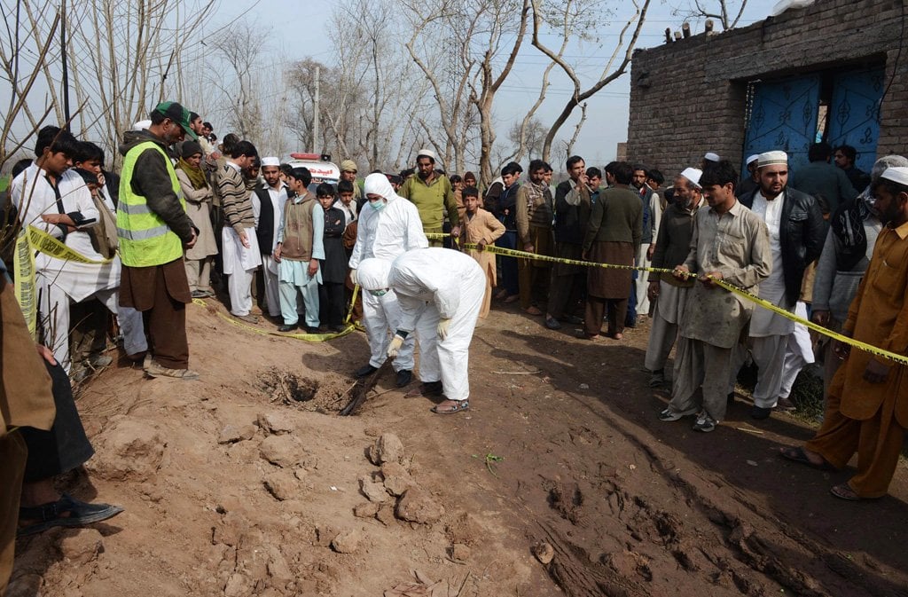 security officials inspect the site of a suicide bombing in peshawar on february 10 2014 photo afp