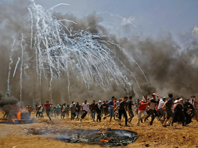 teargas canisters fired by israeli security forces explode above palestinian demonstrators as they run for cover photo afp teargas canisters fired by israeli security forces explode above palestinian demonstrators as they run for cover photo afp