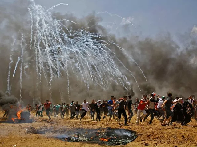 teargas canisters fired by israeli security forces explode above palestinian demonstrators as they run for cover photo afp teargas canisters fired by israeli security forces explode above palestinian demonstrators as they run for cover photo afp