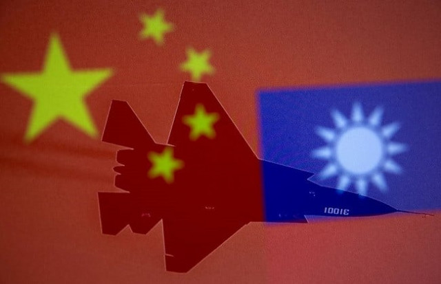 chinese and taiwanese national flags are displayed alongside a military airplane in this illustration taken april 9 2021 photo reuters