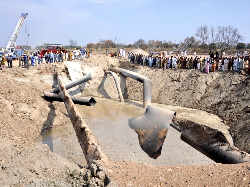 residents gather as sngpl staff repairs the damaged gas pipelines photo reuters