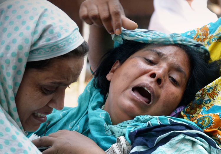 christians mourn the death of relatives at all saints church in peshawar on september 24 2013 photo afp