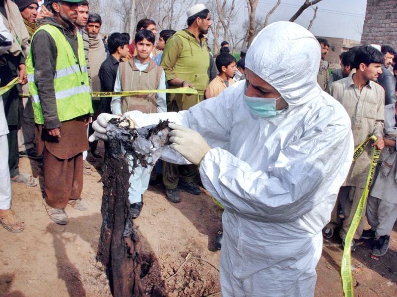 explosives experts collect evidence at the site of the suicide blast in peshawar photo app