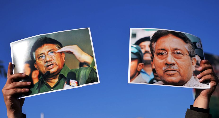 a supporter of pervez musharraf holds up posters bearing his image during a rally in islamabad on january 15 2014 photo afp